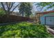 Beautiful backyard with manicured lawn, mature trees, and brick accents throughout the yard at 12378 E Cedar Cir, Aurora, CO 80012