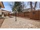 Spacious stamped concrete patio with a covered area, framed by a dark wood privacy fence and professional landscaping at 12378 E Cedar Cir, Aurora, CO 80012