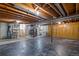 Large basement with concrete walls and floors, exposed wood ceiling and laundry equipment at 12378 E Cedar Cir, Aurora, CO 80012