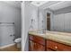 Bathroom showcasing granite countertop, modern sink, and a large mirror over wood cabinets at 12378 E Cedar Cir, Aurora, CO 80012