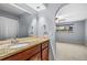 Modern bathroom showing a granite countertop and a large mirror with natural light at 12378 E Cedar Cir, Aurora, CO 80012