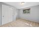 Carpeted bedroom with a window, closet, and light-colored walls, offering a cozy and inviting space at 12378 E Cedar Cir, Aurora, CO 80012