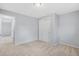 Carpeted bedroom with closet and doorway to an adjacent room at 12378 E Cedar Cir, Aurora, CO 80012