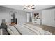 Bright bedroom featuring a ceiling fan, carpet, fresh paint, arched doorway to bathroom, and closet at 12378 E Cedar Cir, Aurora, CO 80012