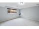 Neutral bedroom with a large window providing natural light and plush carpet at 12378 E Cedar Cir, Aurora, CO 80012