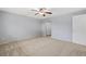 View of spacious bedroom, featuring soft carpet, neutral paint, a ceiling fan, and closet doors at 12378 E Cedar Cir, Aurora, CO 80012