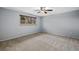 This is an empty bedroom with carpet, a window, and a ceiling fan at 12378 E Cedar Cir, Aurora, CO 80012