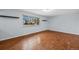Bright bedroom with sleek hardwood floors, modern shelving, and a large window offering natural light at 12378 E Cedar Cir, Aurora, CO 80012
