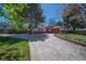 Charming single-story home featuring a red front door and lush landscaping at 12378 E Cedar Cir, Aurora, CO 80012