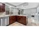 Well-lit kitchen featuring an island, stainless steel appliances, and tile backsplash at 12378 E Cedar Cir, Aurora, CO 80012
