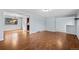 Open living room featuring hardwood floors and natural light from a large window at 12378 E Cedar Cir, Aurora, CO 80012