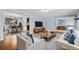 Stylishly furnished living room with hardwood floors, opening into dining area and featuring chic decor at 12378 E Cedar Cir, Aurora, CO 80012