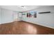 Living room featuring hardwood floors, light blue walls, and a large window at 12378 E Cedar Cir, Aurora, CO 80012
