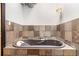 Modern bathtub is surrounded by custom tile work at 1745 Wazee St # 5E, Denver, CO 80202