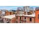 An urban view shows cityscape, brick building rooftops, and city skyline in the distance at 1745 Wazee St # 5E, Denver, CO 80202