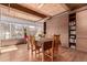 Bright dining room with wooden table and chairs, built-in shelving, and large windows at 1745 Wazee St # 5E, Denver, CO 80202