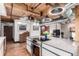 Kitchen featuring a large island with modern stove, unique lights, stainless steel appliances, and wood ceiling at 1745 Wazee St # 5E, Denver, CO 80202