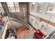 Living area featuring an open staircase, tall windows, and exposed brick walls at 1745 Wazee St # 5E, Denver, CO 80202