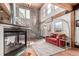 Sunlit living room with a fireplace, wooden beamed ceiling and spiral staircase at 1745 Wazee St # 5E, Denver, CO 80202