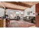Bright living room with wood-beamed ceiling, large windows, and a comfortable seating area at 1745 Wazee St # 5E, Denver, CO 80202