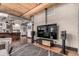 Open concept living room with modern entertainment center and industrial style ceiling at 1745 Wazee St # 5E, Denver, CO 80202