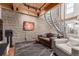 Cozy living room with exposed brick wall and unique spiral staircase at 1745 Wazee St # 5E, Denver, CO 80202