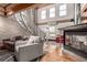 Bright living room featuring a fireplace, spiral staircase, and wood floors at 1745 Wazee St # 5E, Denver, CO 80202