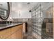 Bathroom featuring modern cabinets, granite countertops and glass block walk-in shower at 1745 Wazee St # 5E, Denver, CO 80202