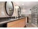 Bright main bathroom features double sinks, granite countertops, glass block walk-in shower and tile floors at 1745 Wazee St # 5E, Denver, CO 80202