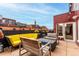 Cozy rooftop patio with comfortable seating around a fire pit, perfect for relaxing outdoors at 1745 Wazee St # 5E, Denver, CO 80202