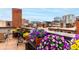 Rooftop terrace with potted flowers and outdoor seating area with views of the city skyline at 1745 Wazee St # 5E, Denver, CO 80202