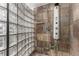 Shower featuring glass block, stone tile and modern shower head at 1745 Wazee St # 5E, Denver, CO 80202
