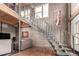 View of open staircase connecting floors with decorative wall finishes and modern living space at 1745 Wazee St # 5E, Denver, CO 80202