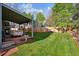 Well-maintained backyard features a covered patio and lush green lawn at 12705 Home Farm Dr, Westminster, CO 80234