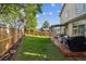 Picturesque backyard featuring a deck, green grass, wooden fence, and the home's exterior at 12705 Home Farm Dr, Westminster, CO 80234