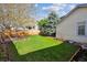 Lush backyard featuring green lawn, privacy fence, and view of the home's siding at 12705 Home Farm Dr, Westminster, CO 80234