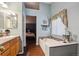 Bright and airy bathroom featuring a bathtub, with bedroom access creating a relaxing and comfortable retreat at 12705 Home Farm Dr, Westminster, CO 80234
