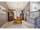 The dining room features a wooden table set, matching china cabinet, and chandelier, blending classic elegance with modern design at 12705 Home Farm Dr, Westminster, CO 80234