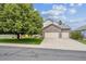Charming two-story home featuring a stone facade and a large tree in the front yard at 12705 Home Farm Dr, Westminster, CO 80234
