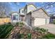 Beautiful two-story home showcasing the front yard with decorative rocks and landscaping and a two car garage at 12705 Home Farm Dr, Westminster, CO 80234