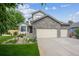 Beautiful two-story home with stone details, an attached garage, and a landscaped front yard at 12705 Home Farm Dr, Westminster, CO 80234