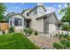Charming home featuring stone accents, a well-manicured lawn, and a welcoming entrance at 12705 Home Farm Dr, Westminster, CO 80234