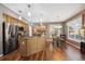 Bright, open kitchen with stainless steel appliances, an island, granite counters, and a breakfast nook with backyard views at 12705 Home Farm Dr, Westminster, CO 80234