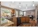 Kitchen featuring wood cabinets, granite countertops, stainless steel appliances, and an adjacent breakfast nook with views at 12705 Home Farm Dr, Westminster, CO 80234