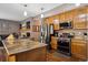 A fully equipped kitchen with stainless steel appliances, granite countertops, wood cabinets, and an island, perfect for cooking at 12705 Home Farm Dr, Westminster, CO 80234