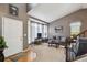 Well-lit living room with modern decor, featuring comfortable seating, vaulted ceilings, and bright, large windows at 12705 Home Farm Dr, Westminster, CO 80234