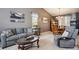 Open-concept living space with neutral tones, comfortable seating, and dining area featuring a wooden table set at 12705 Home Farm Dr, Westminster, CO 80234