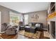 Relaxing living room features a fireplace, comfortable seating, and large window at 12705 Home Farm Dr, Westminster, CO 80234