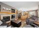Inviting living room includes fireplace, wood floors, and an open layout to the kitchen at 12705 Home Farm Dr, Westminster, CO 80234
