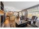Spacious living room with a fireplace, kitchen view, plush seating, and an open layout, perfect for entertaining and relaxing at 12705 Home Farm Dr, Westminster, CO 80234